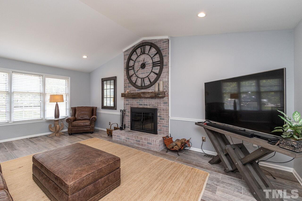 4808 Waybridge Court Raleigh, NC 27606 - Photo 7 of 29 a living room with furniture and a flat screen tv