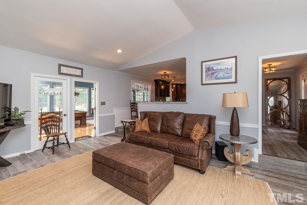 4808 Waybridge Court Raleigh, NC 27606 - Photo 8 of 29 a living room with furniture and a wooden floor