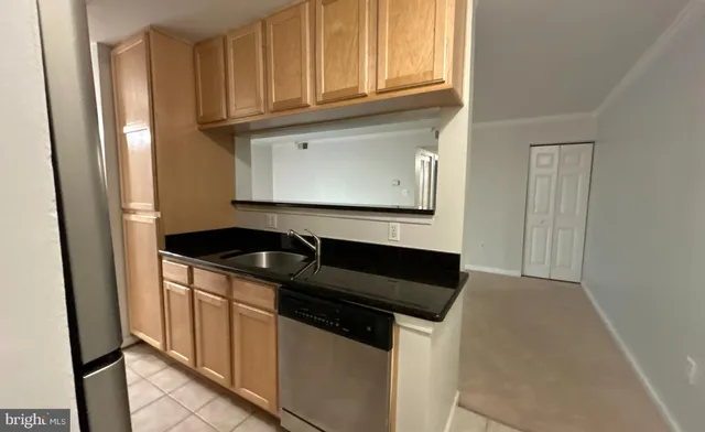 a kitchen with granite countertop white cabinets and black appliances