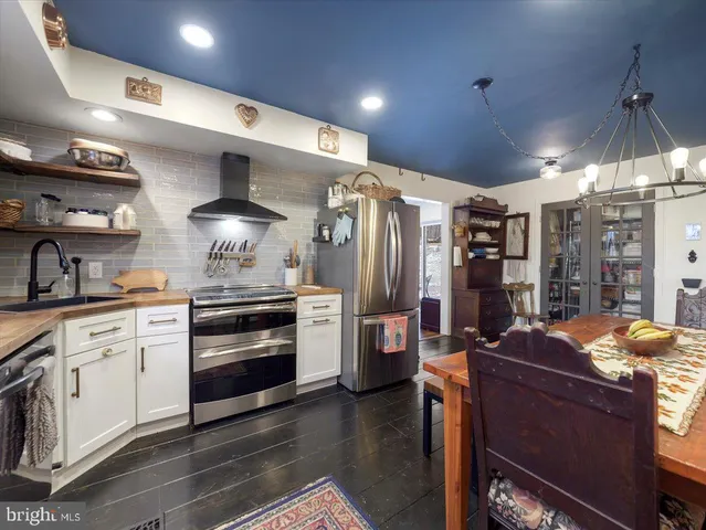 a bedroom with bed and wooden floor