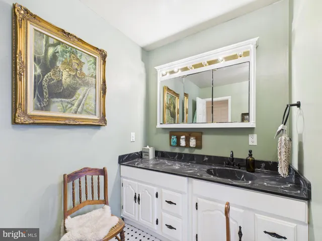 a living room with furniture a rug and a window