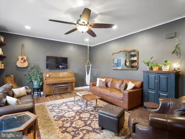 a living room with furniture and a book shelf