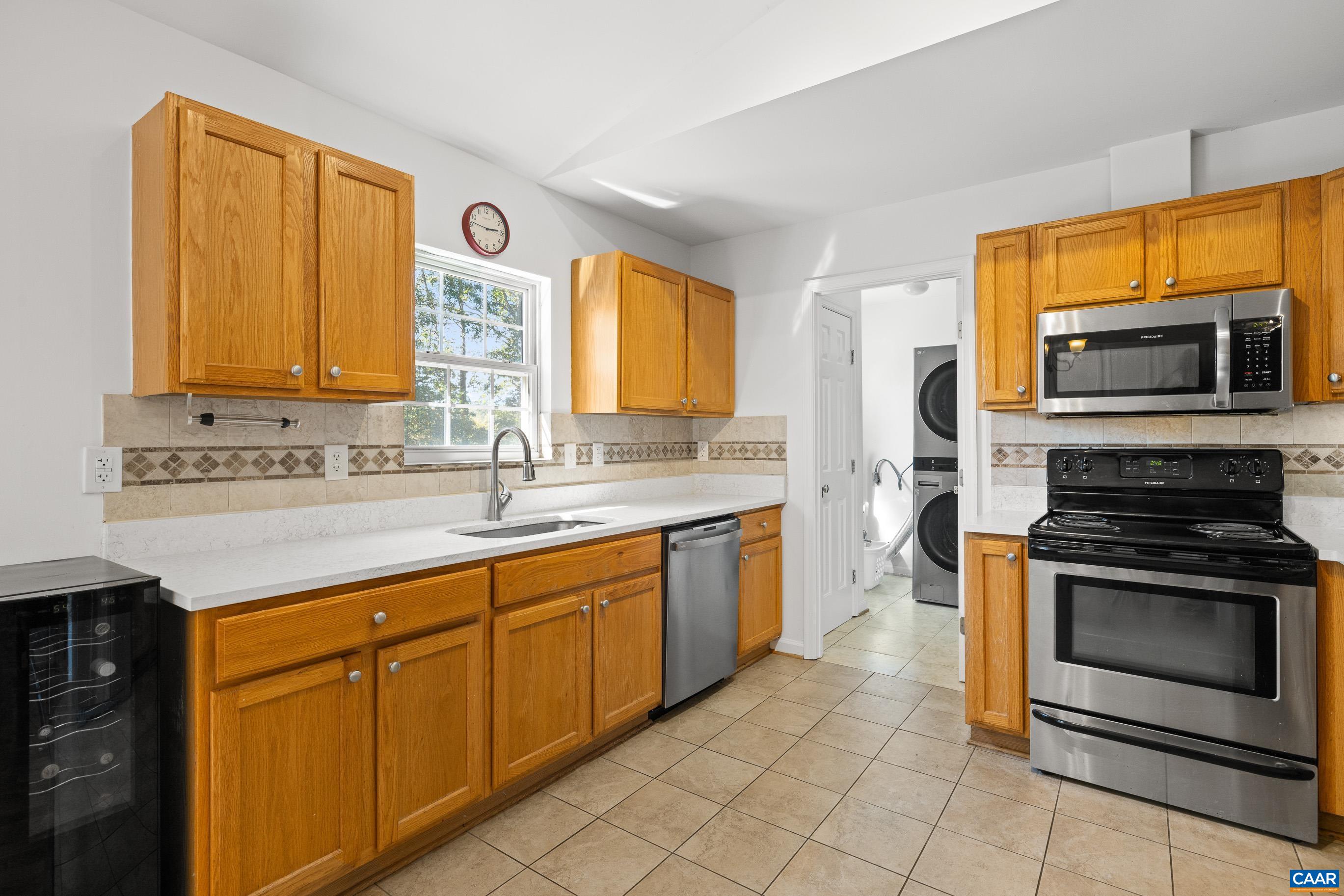 528 Jonquil Road Ruckersville, VA 22968 - Photo 33 of 66 a kitchen with stainless steel appliances granite countertop a stove a sink and a microwave