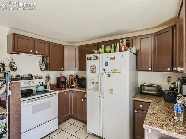 a white refrigerator freezer sitting inside of a kitchen