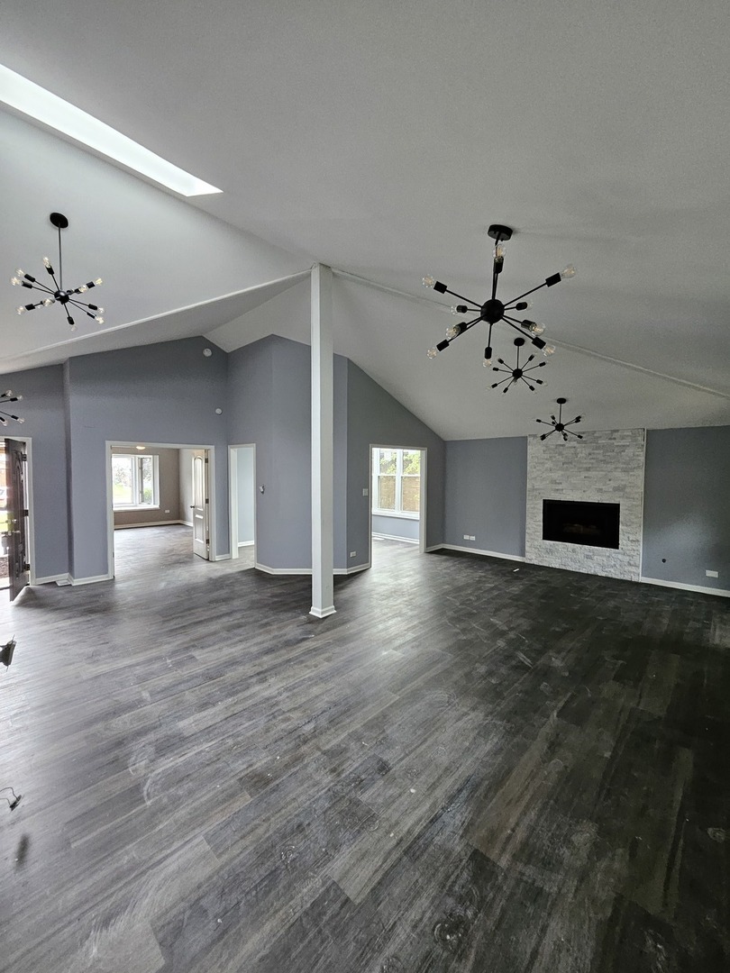 17612 Wright Street Lansing, IL 60438 - Photo 15 of 40 a view of a livingroom with a fireplace wooden floor and windows