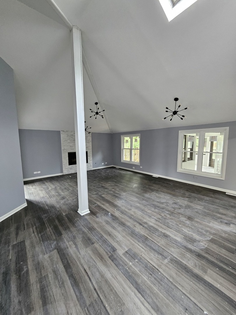 17612 Wright Street Lansing, IL 60438 - Photo 17 of 40 an empty room with wooden floor and windows
