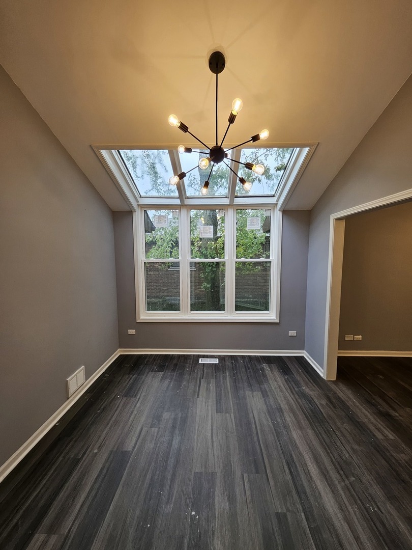 17612 Wright Street Lansing, IL 60438 - Photo 20 of 40 a view of an empty room with wooden floor and a window