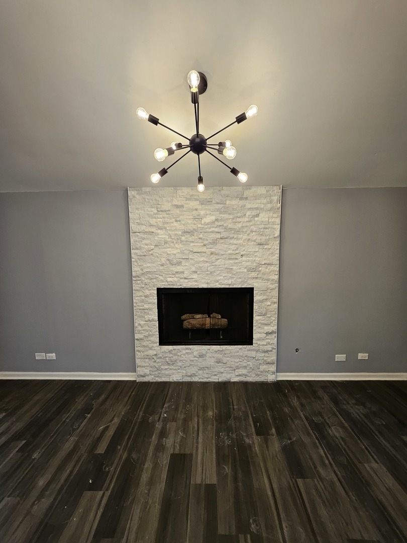 17612 Wright Street Lansing, IL 60438 - Photo 26 of 40 a view of wooden floor fire place and windows in a room