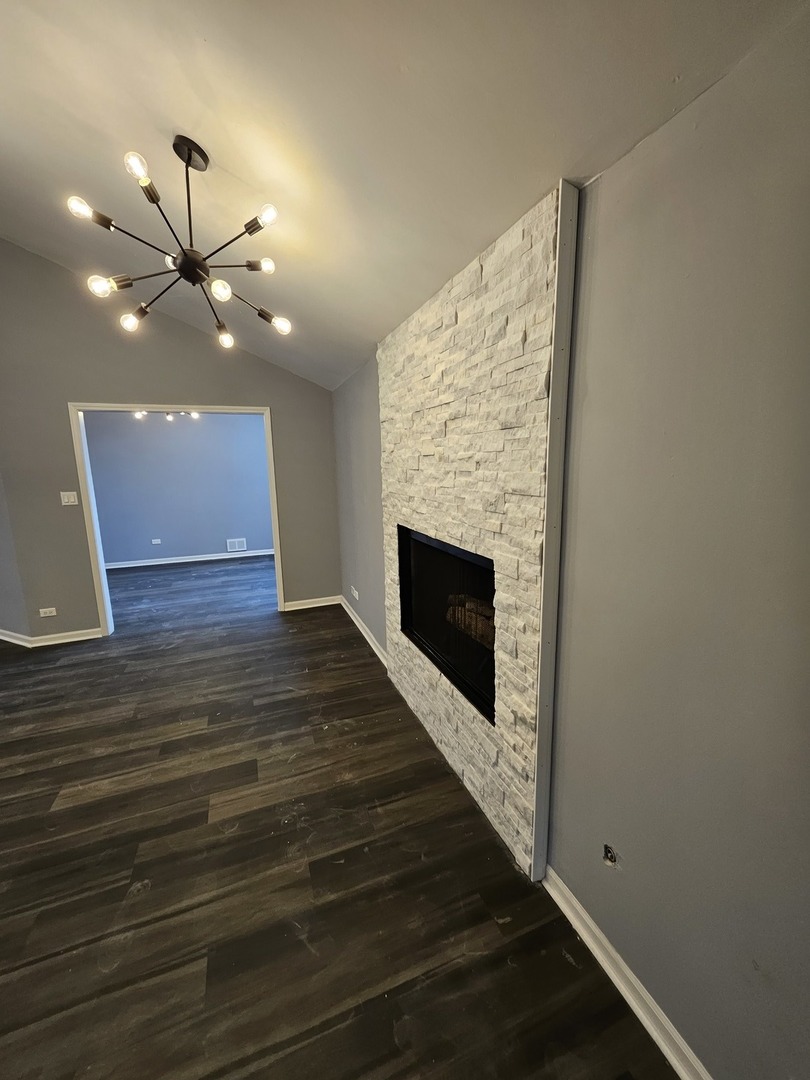 17612 Wright Street Lansing, IL 60438 - Photo 27 of 40 a view of an empty room with wooden floor and a fireplace