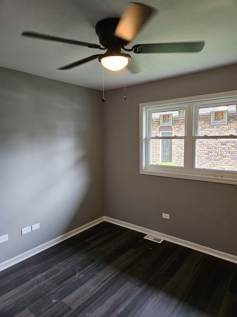 17612 Wright Street Lansing, IL 60438 - Photo 34 of 40 an empty room with wooden floor and windows