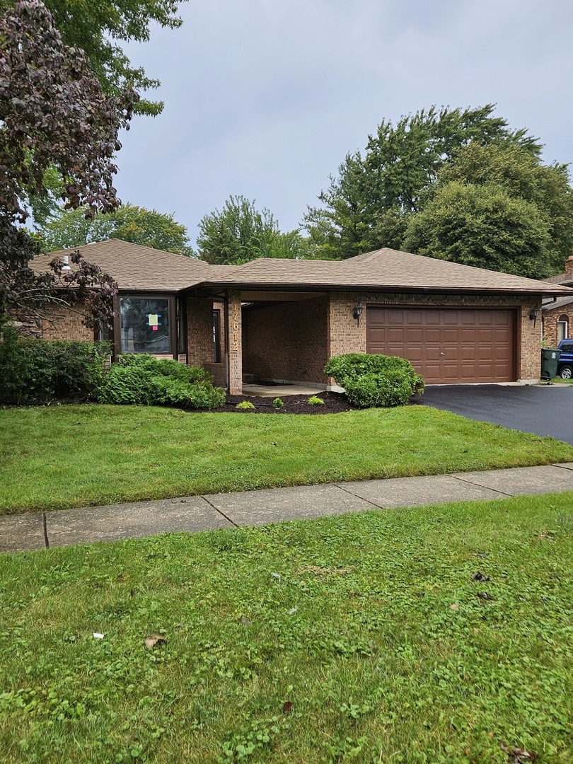 17612 Wright Street Lansing, IL 60438 - Photo 40 of 40 a front view of a house with a garden
