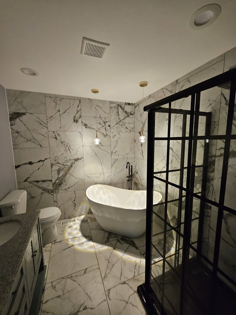 17612 Wright Street Lansing, IL 60438 - Photo 4 of 40 a bathroom with a toilet and a shower