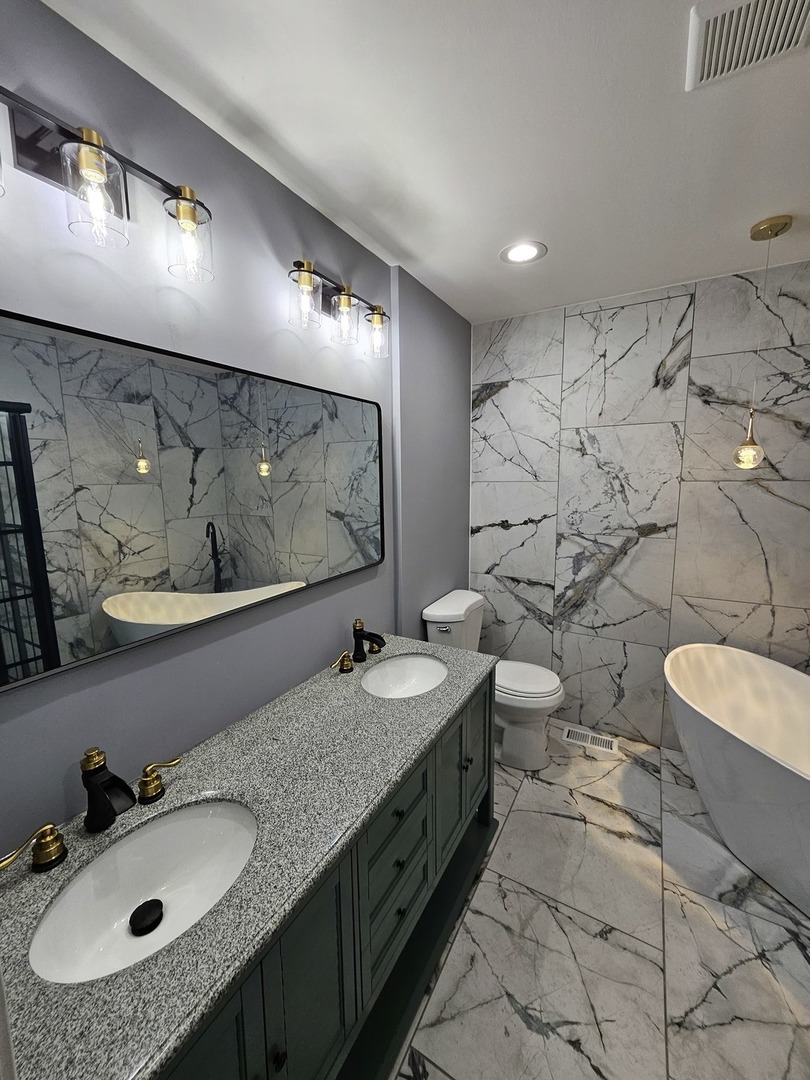 17612 Wright Street Lansing, IL 60438 - Photo 8 of 40 a bathroom with double vanity sinks double vanity and a mirror