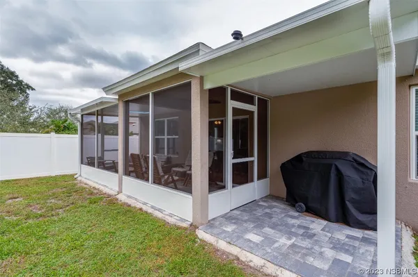 a backyard of a house with plants and large trees