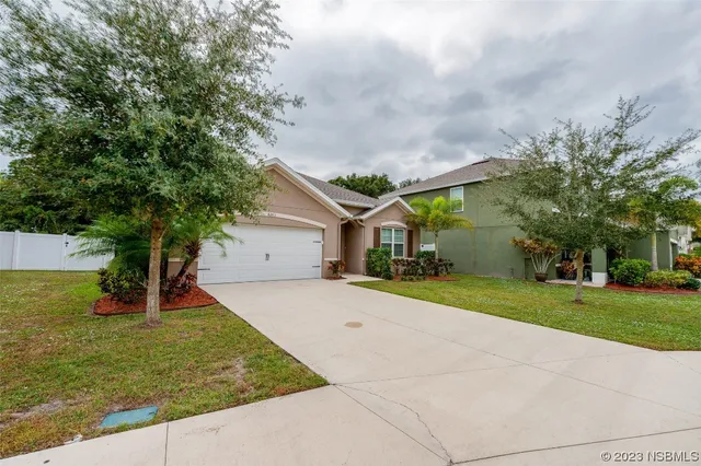 a sign broad in front of flowers