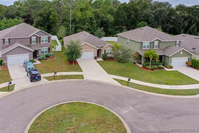 an aerial view of residential house with outdoor space and swimming pool