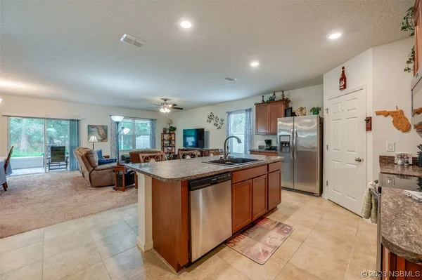 a kitchen with stainless steel appliances granite countertop a stove and a refrigerator