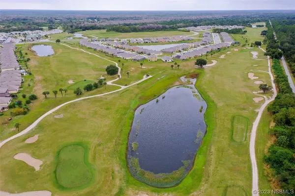 an aerial view of a house with garden space and outdoor seating