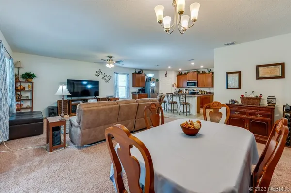 a view of a dining room with furniture and a flat screen tv