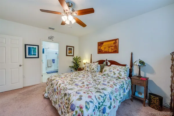 a bed sitting in a bedroom and a flat screen tv