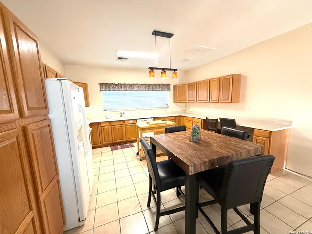 a view of a kitchen with a table and chairs