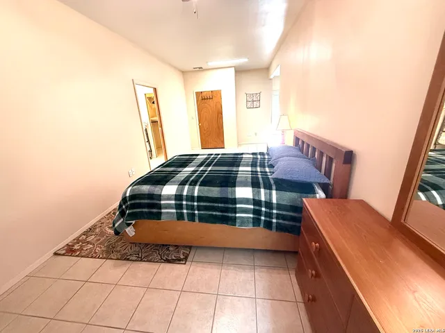 a bedroom with a bed and a dresser