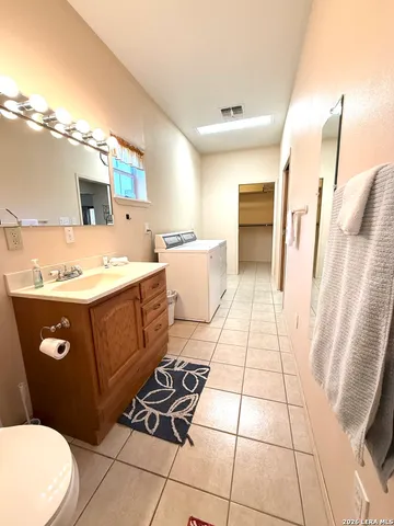 a bathroom with a sink a toilet and mirror