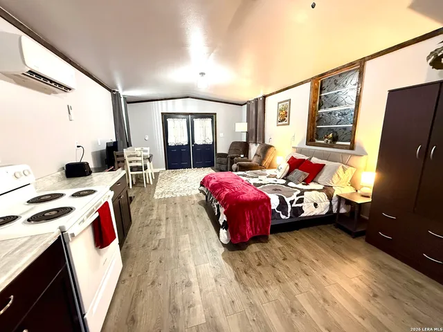 a bedroom with furniture and a flat screen tv