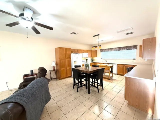 a view of a dining room with furniture and chandelier