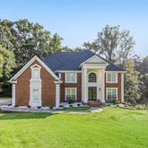 a front view of house with yard and swimming pool