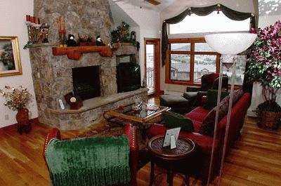111 Knudson Ranch Road, Unit 13 Edwards, CO 81632 - Photo 1 of 4 a living room with furniture a window and a fireplace