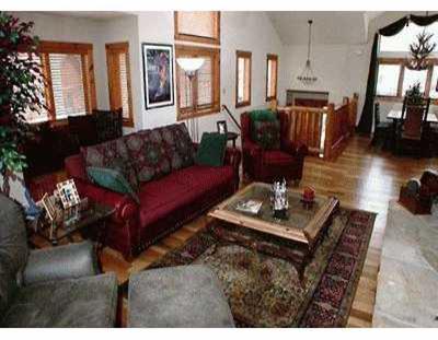 111 Knudson Ranch Road, Unit 13 Edwards, CO 81632 - Photo 2 of 4 a living room with furniture and wooden floor