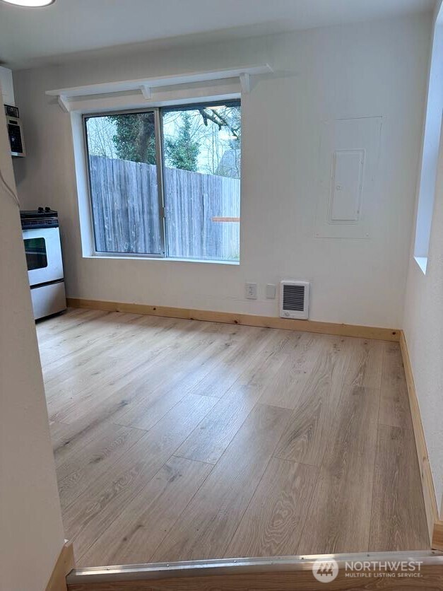 10341 184th Avenue Southwest Rochester, WA 98579 - Photo 35 of 36 an empty room with wooden floor and windows