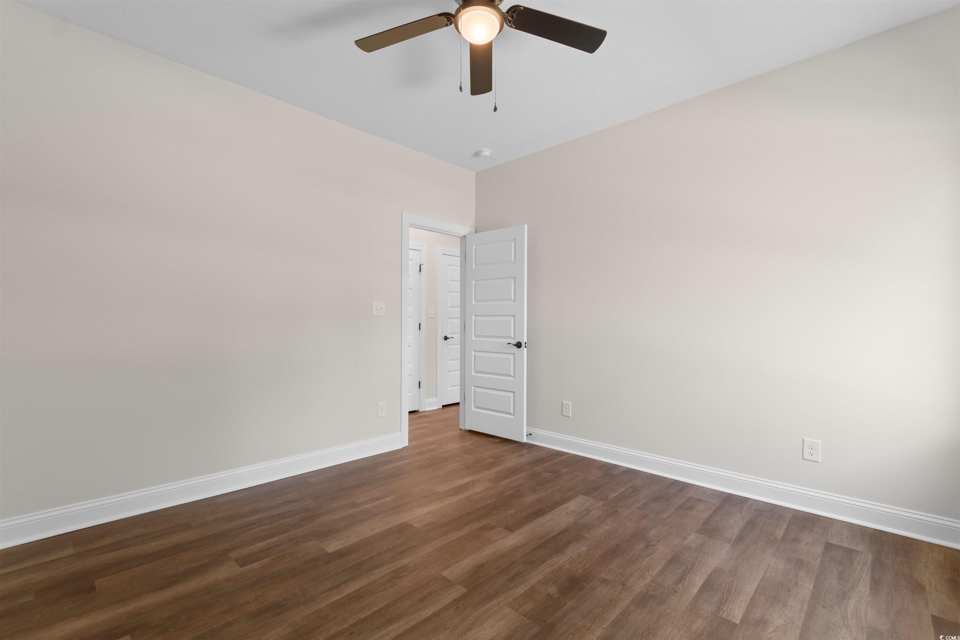 146 Temple Drive Aynor, SC 29511 - Photo 19 of 40 Empty room featuring dark wood finished floors and baseboards