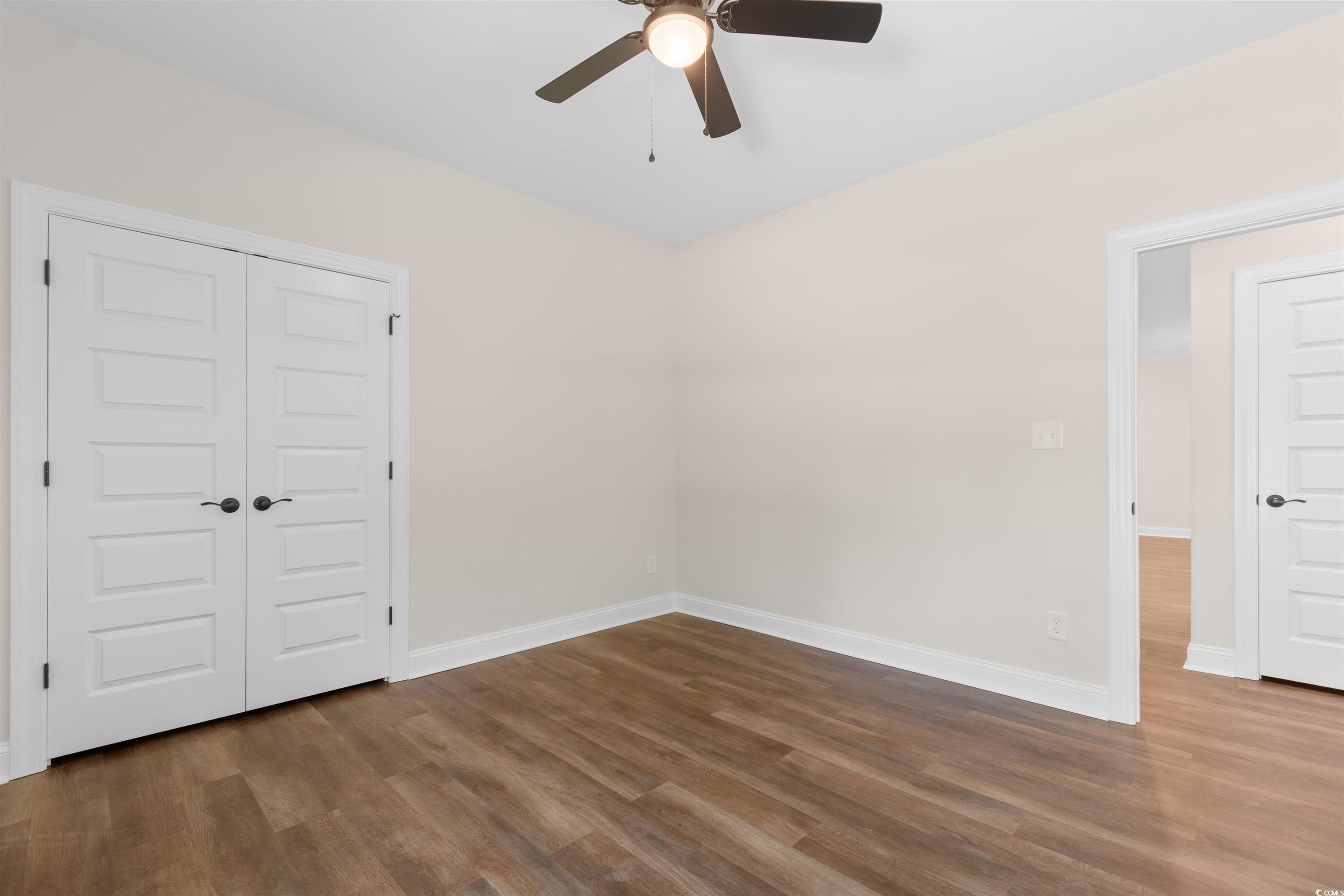 146 Temple Drive Aynor, SC 29511 - Photo 20 of 40 Unfurnished room with dark wood-style floors and a ceiling fan