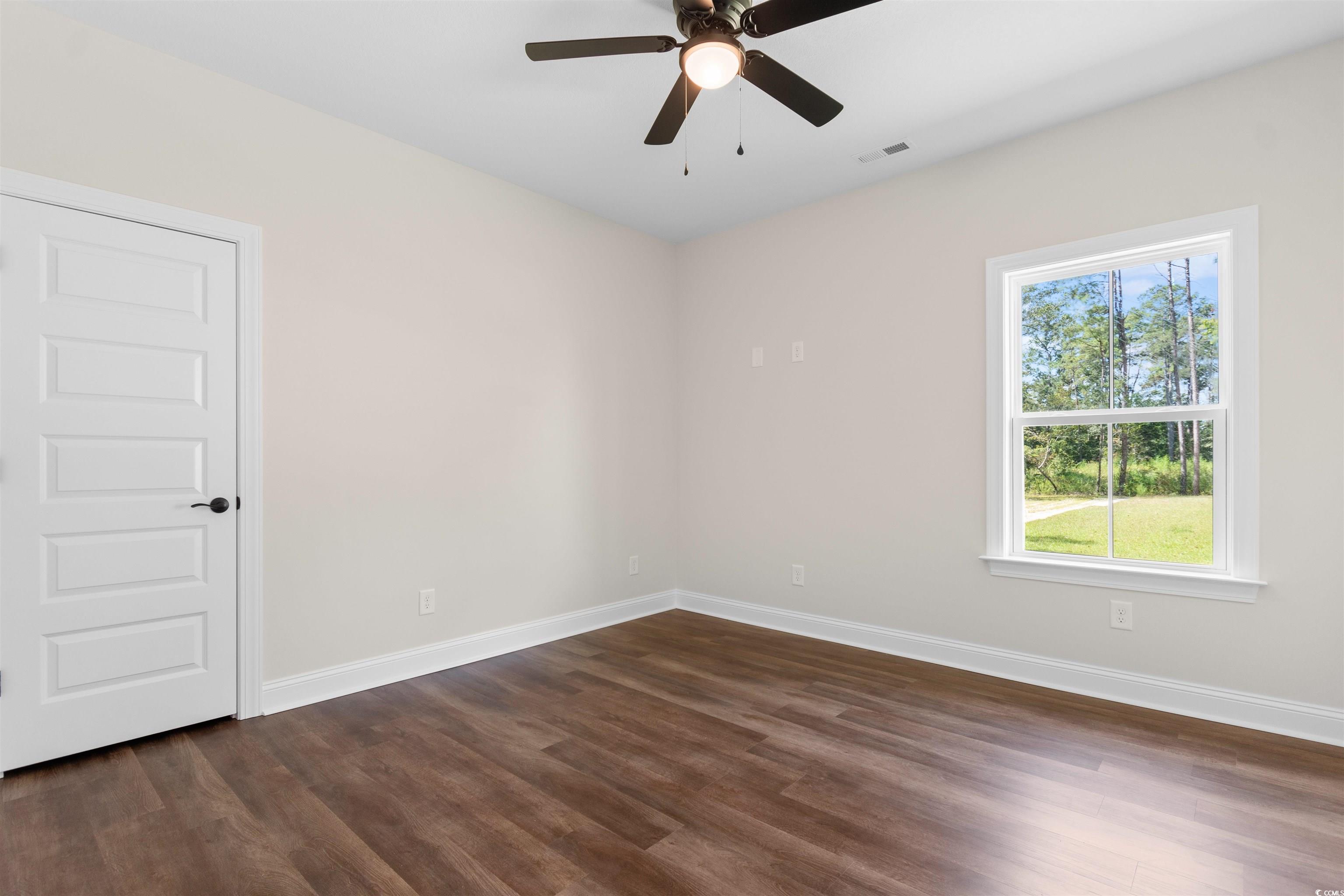 146 Temple Drive Aynor, SC 29511 - Photo 22 of 40 Empty room featuring dark wood-type flooring and ceiling fan