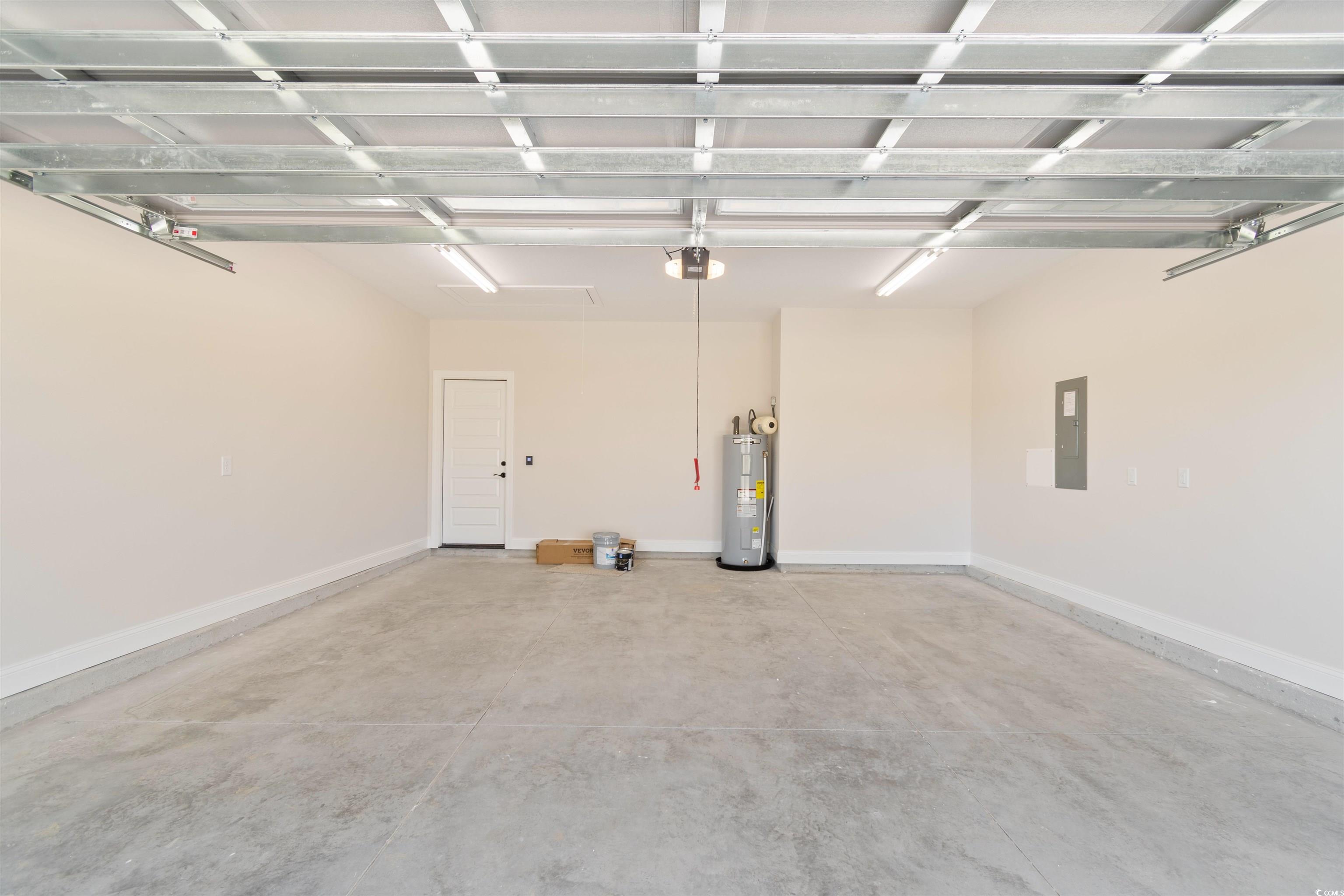 146 Temple Drive Aynor, SC 29511 - Photo 26 of 40 Garage with electric panel, water heater, and a garage door opener