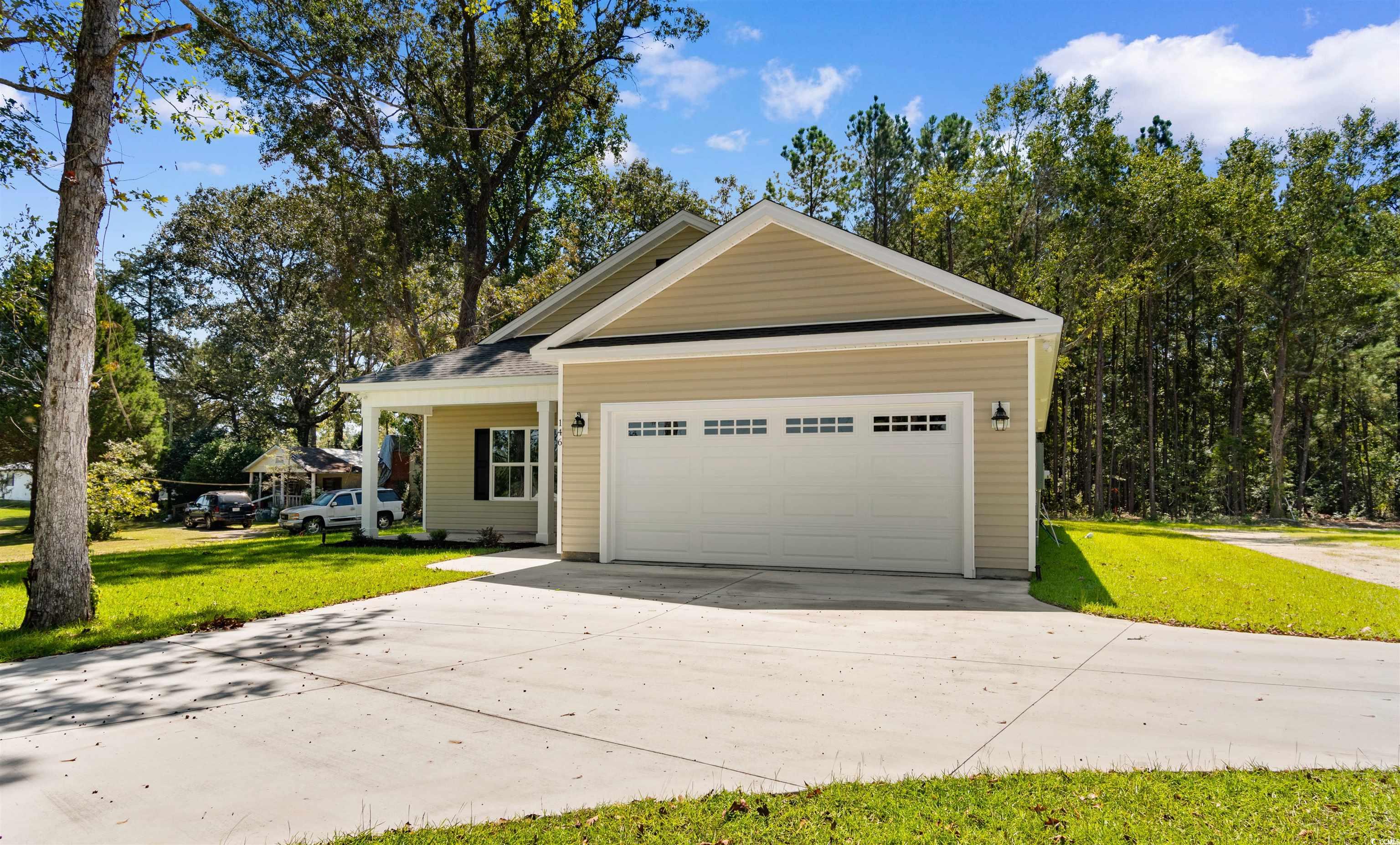 146 Temple Drive Aynor, SC 29511 - Photo 30 of 40 View of front of home featuring driveway, a front lawn, and an attached garage