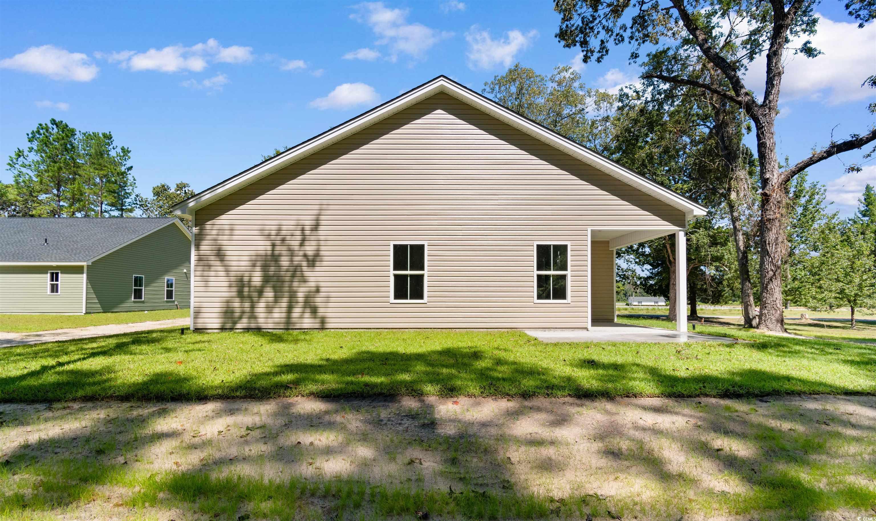 146 Temple Drive Aynor, SC 29511 - Photo 32 of 40 View of property exterior with a patio and a yard