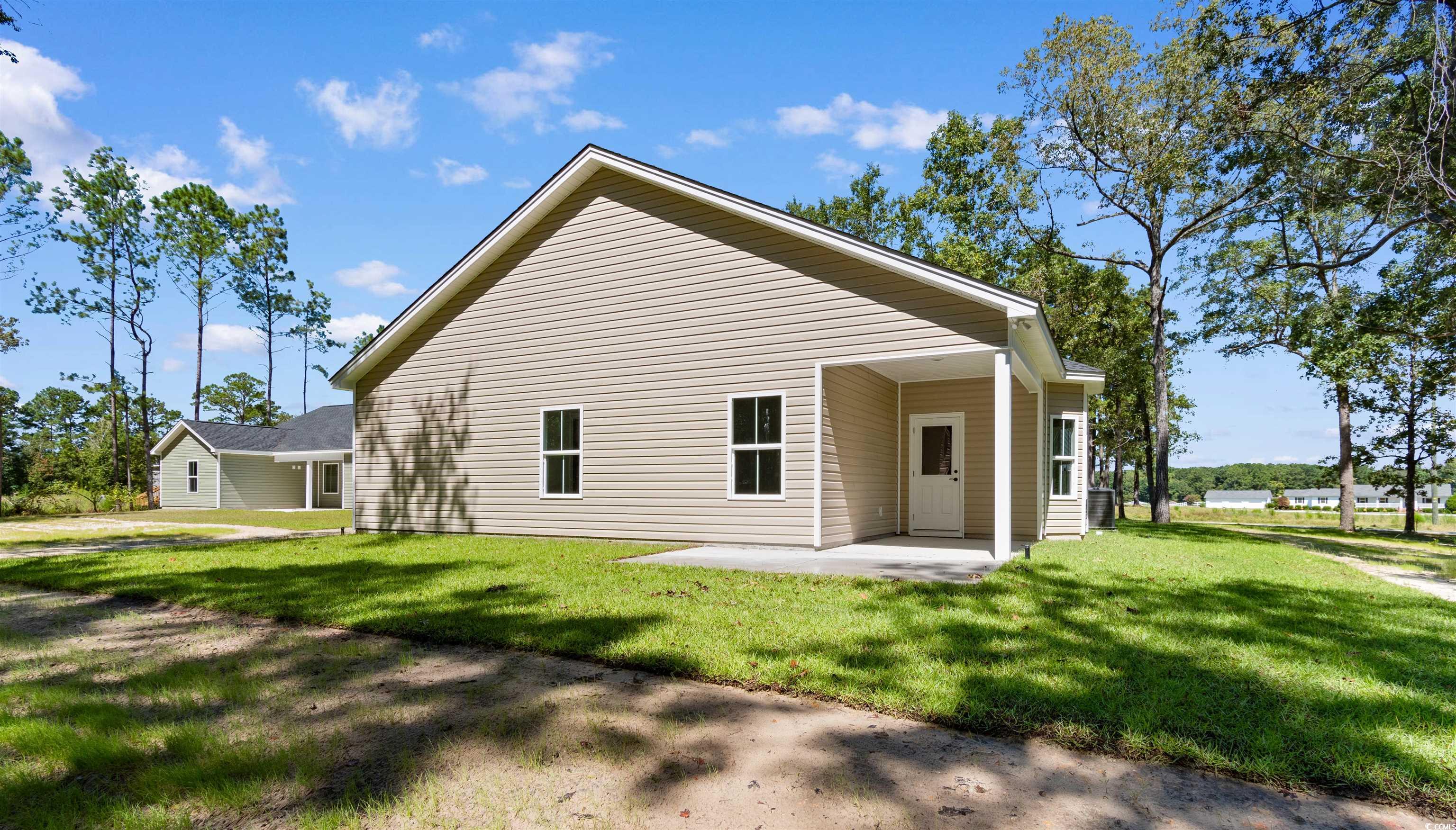 146 Temple Drive Aynor, SC 29511 - Photo 33 of 40 Rear view of house featuring a patio area and a yard