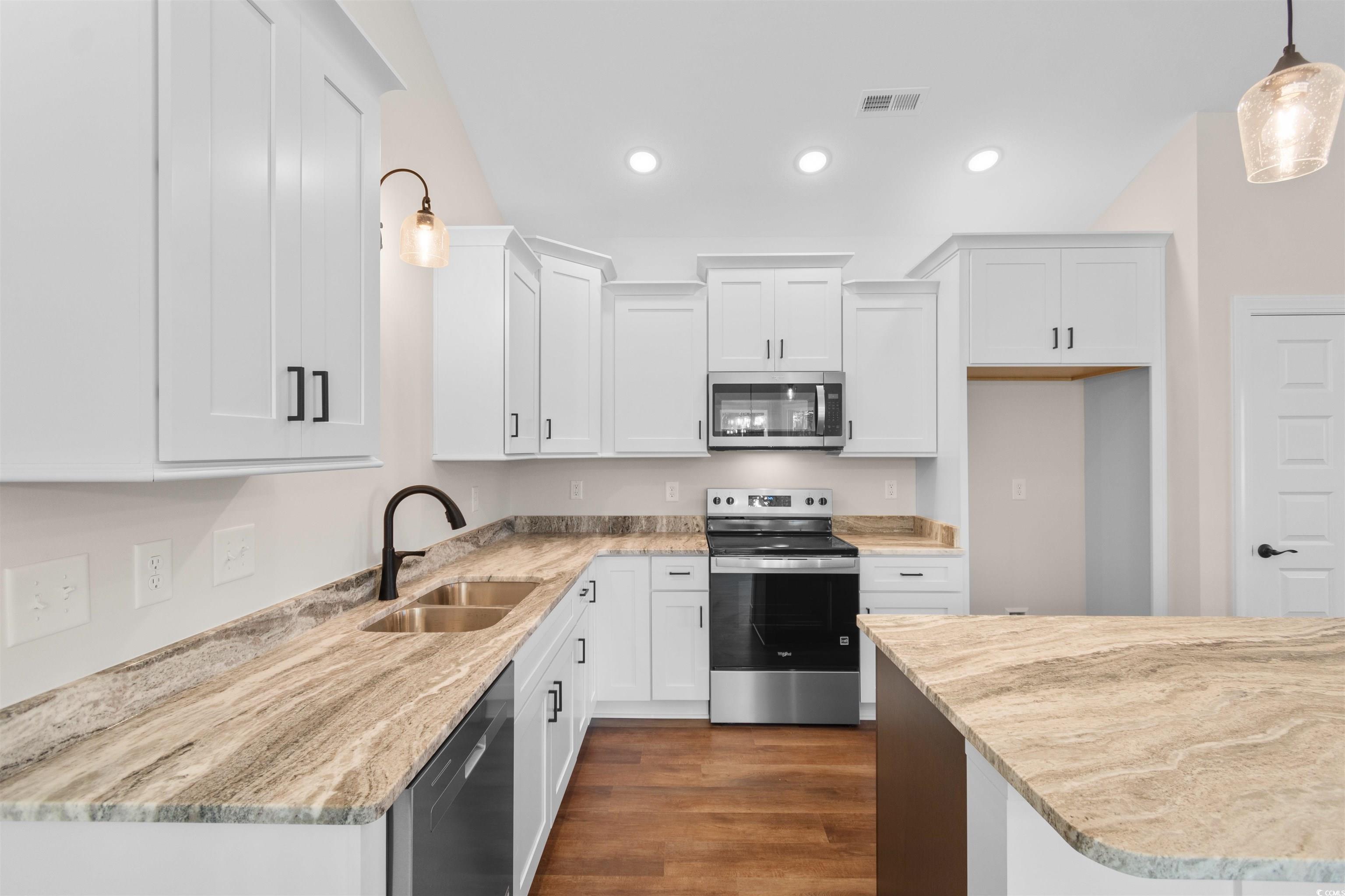 146 Temple Drive Aynor, SC 29511 - Photo 4 of 40 Kitchen featuring pendant lighting, stainless steel appliances, dark wood-type flooring, white cabinetry, and recessed lighting