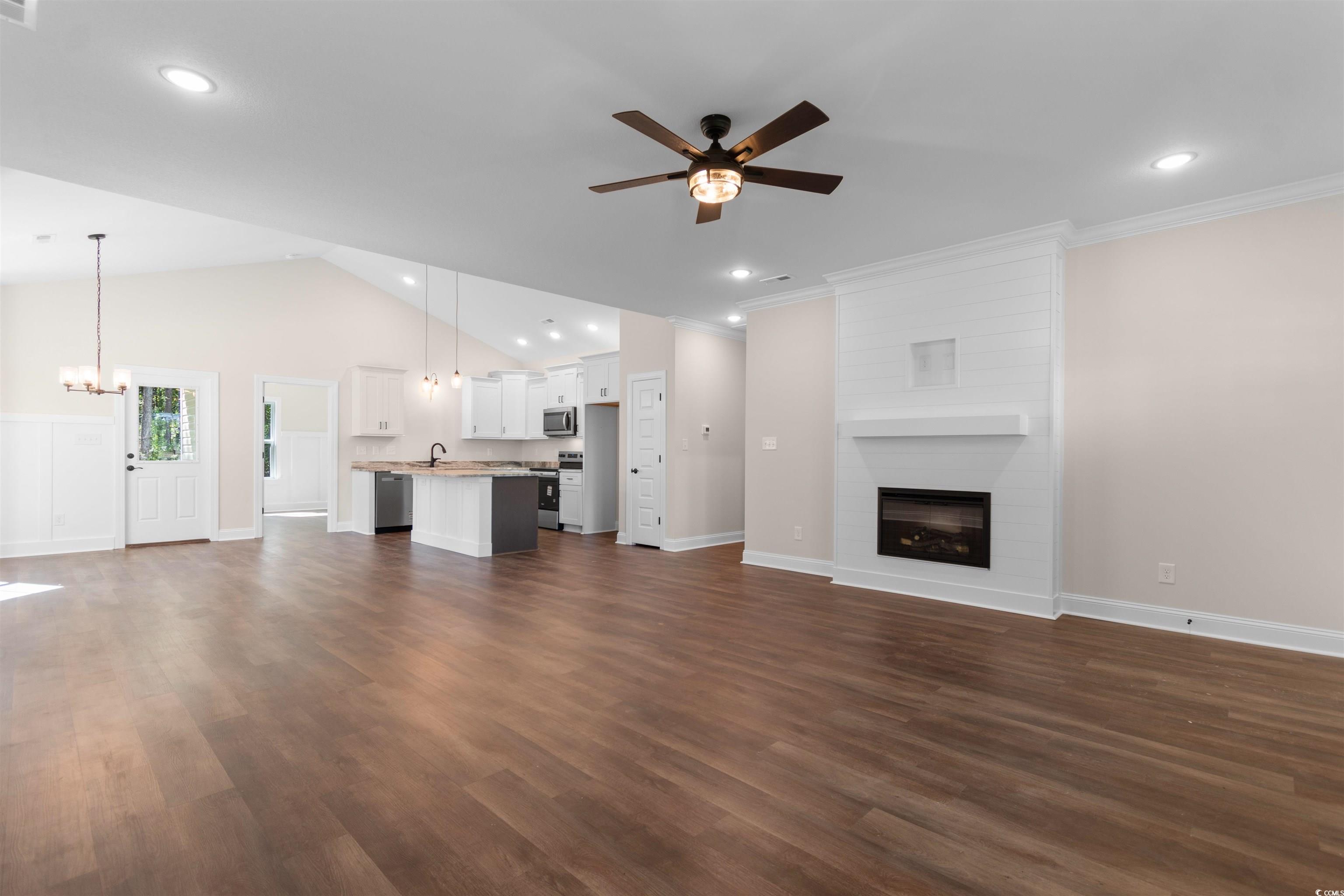 146 Temple Drive Aynor, SC 29511 - Photo 9 of 40 Unfurnished living room featuring a fireplace, dark wood-style flooring, ceiling fan, lofted ceiling, and recessed lighting