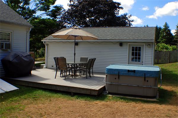 16 Sibley Street Three Rivers, MA 01080 - Photo 4 of 27 a view of a patio with table and chairs under an umbrella