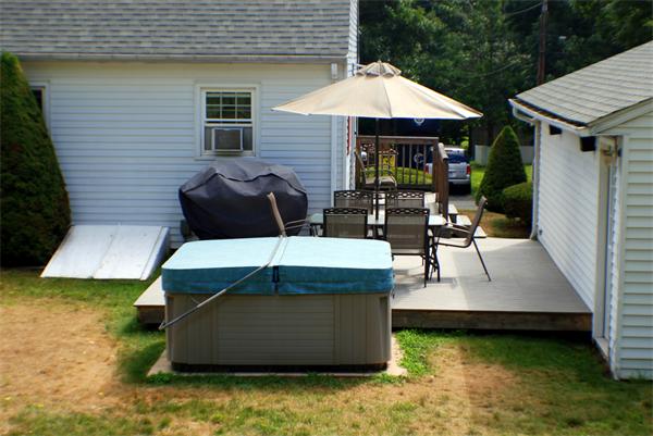 16 Sibley Street Three Rivers, MA 01080 - Photo 5 of 27 a view of a patio with table and chairs under an umbrella
