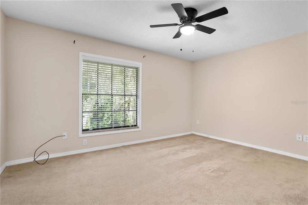7337 Cedar Creek Court, Unit 75 Winter Park, FL 32792 - Photo 13 of 26 wooden floor in an empty room with a window
