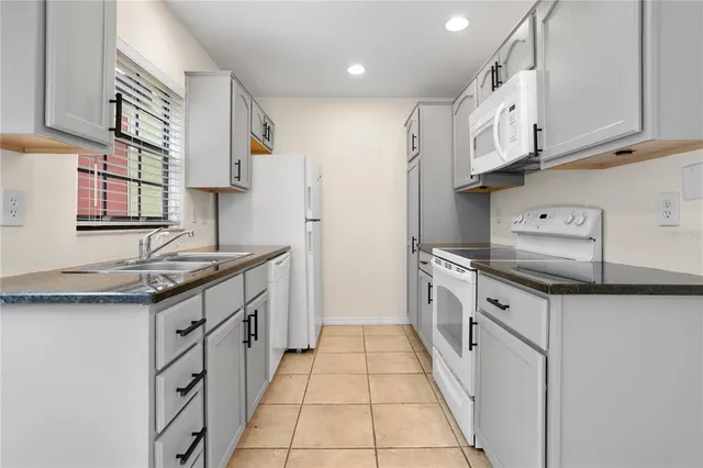 a kitchen with stainless steel appliances granite countertop a sink and a stove
