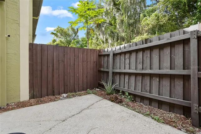 a backyard of a house with wooden fence