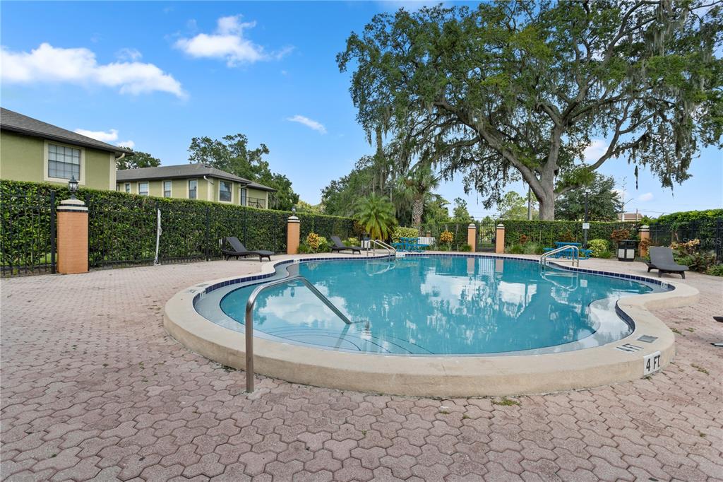 7337 Cedar Creek Court, Unit 75 Winter Park, FL 32792 - Photo 24 of 26 a view of a swimming pool with a patio