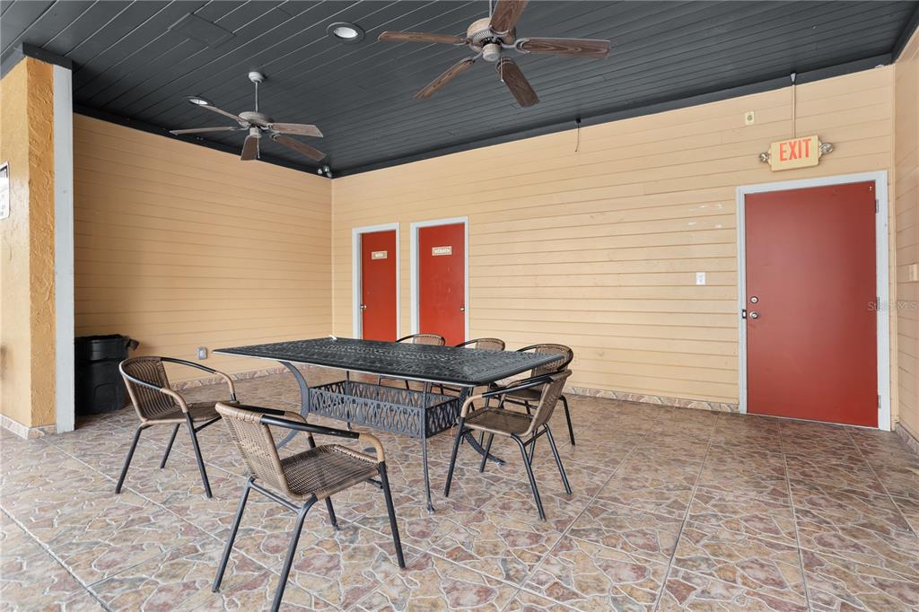 7337 Cedar Creek Court, Unit 75 Winter Park, FL 32792 - Photo 25 of 26 a patio with table and chairs and potted plants