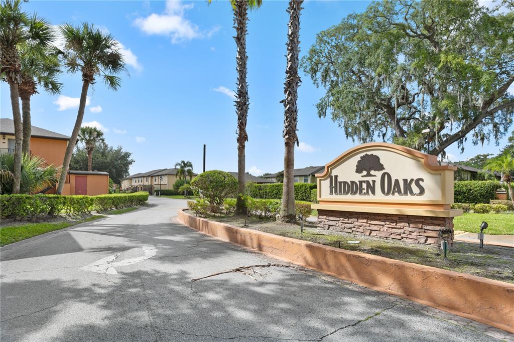 7337 Cedar Creek Court, Unit 75 Winter Park, FL 32792 - Photo 26 of 26 a view of a street sign under a large tree